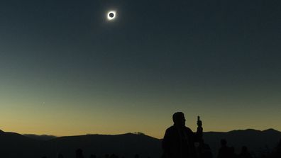 Sun completely eclipsed in Chilean desert.