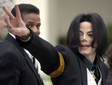 Michael Jackson waves to his supporters as he arrives for his child molestation trial at the Santa Barbara County Superior Court in Santa Maria, Calif. 