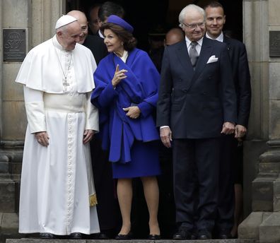 Pope Francis speaks with Queen Silvia and King Carl XVI Gustaf as they leave the King's House in Lund, Sweden, Monday, Oct. 31, 2016. 