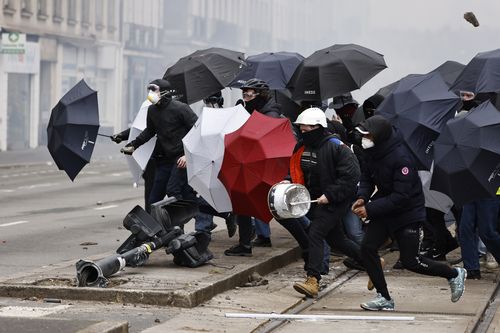 Youths clash with police forces during a protest Thursday, April 6, 2023 in Nantes, western France. 