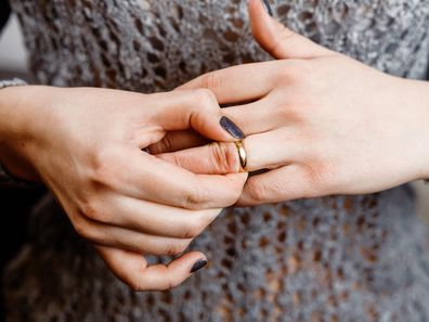 Woman taking off her wedding ring