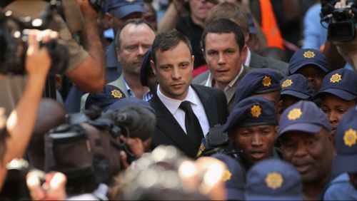 Oscar Pistorius struggles through the crowd as he leaves court. (Getty)