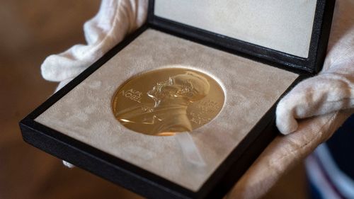 FILE - A Nobel medal is seen at the Swedish ambassador's residence in London, Dec. 8, 2020. (Niklas Halle'n/Pool via AP, File)