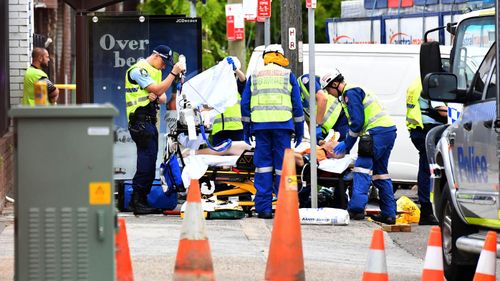 Paramedics work to stabilise one patient following a horrific truck crash in Sydney's south.