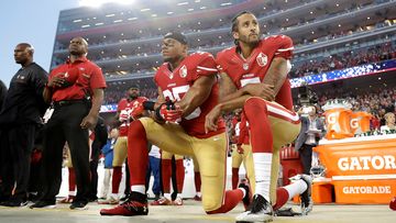 San Francisco 49ers safety Eric Reid (left) and quarterback Colin Kaepernick kneel during the national anthem before a 2016 NFL football game against the Los Angeles Rams.