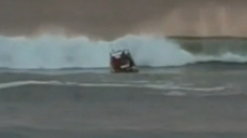 Two fishermen have been saved in a dramatic rescue, after their boat capsized, trapping one of the men underneath.