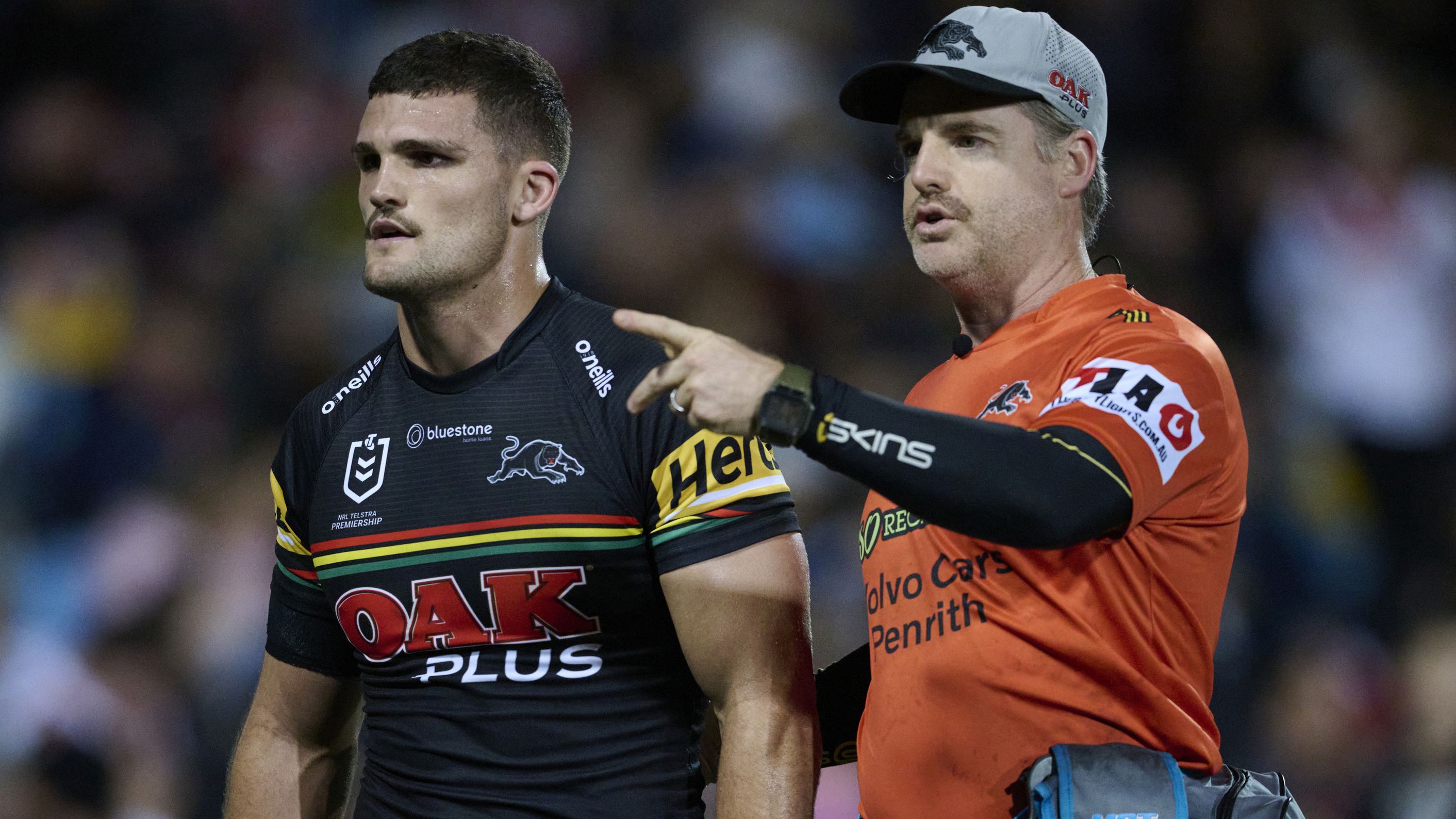 Nathan Cleary is assisted off the field by a Panthers trainer after suffering a hamstring injury