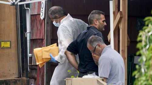 Authorities remove evidence from the Massapequa Park, Long Island, home of suspect Rex Heuermann on Tuesday, July 18.