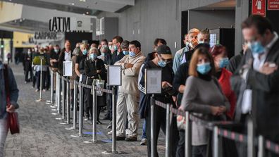 People queue up to receive the coronavirus vaccine in Melbourne.