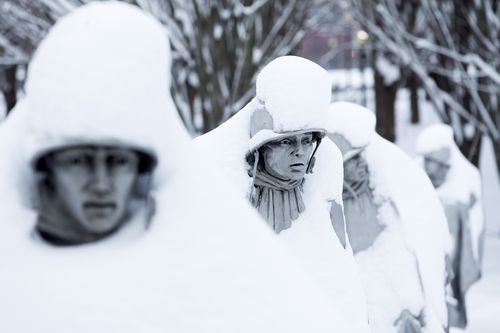 Statues at the Korean War Veterans Memorial are covered in snow in Washington.