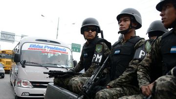 Honduras military police personnel patrol during a public transport strike. (Getty Images)