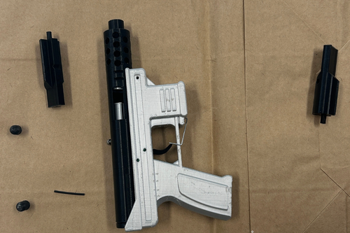 The white and black replica 3D-printed bolt action pistol.