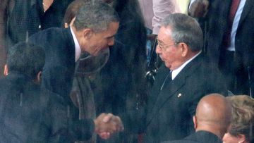 US President Barack Obama shakes hands with his Cuban counterpart Raul Castro at Nelson Mandela's memorial in December 2013. (Getty)