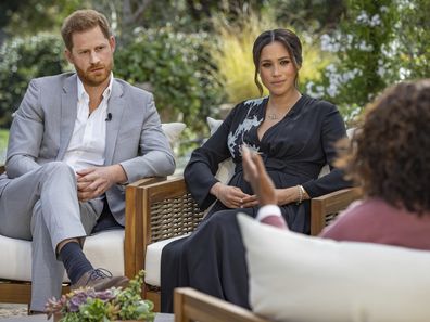 This image provided by Harpo Productions shows Prince Harry, from left, and Meghan, The Duchess of Sussex, in conversation with Oprah Winfrey. (Joe Pugliese/Harpo Productions via AP)