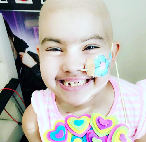 Despite her ongoing health battle, Bella is still determined to smile. (Supplied)
