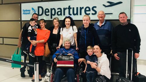 Patricia Hardy (centre) and her family before heading off on her bucket list holiday to Hawaii.