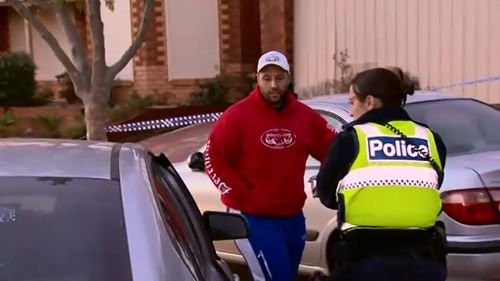 Nikolaos Solomos waits with police for the bomb squad to examine the device. (9NEWS)