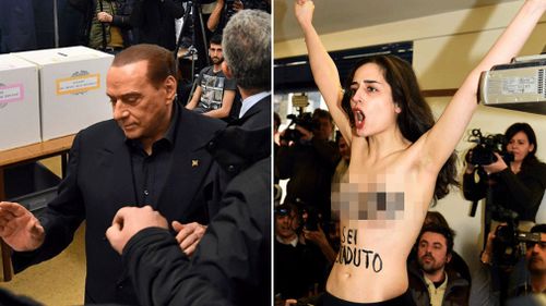 Silvia Berlusconi, and the topless activist at the Milan polling station on Sunday, March 4. (AAP)