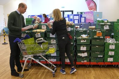 Kate, Princess of Wales, and Prince William collect food during a visit to Windsor Foodshare in Windsor, Thursday, Jan. 26, 2023