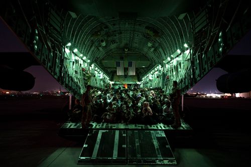 Evacuees board a US military C-17 Globemaster III aircraft at Hamid Karzai International Airport 