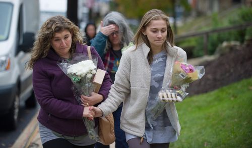 Mourners arrive outside the Tree of Life synagogue a day after the mass shooting.