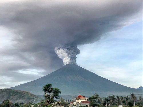 Mount Agung spews ash into the sky on the first day. (AAP) 