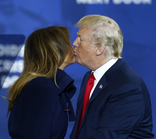 Melania welcomed Trump onstage with a hug and a kiss in a rare public display of affection. (AAP)