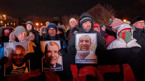 Alexandre Bissonnette is escorted to a van in Quebec City after appearing in court for the deadly shooting at a mosque.