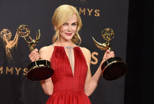 Nicole Kidman holds two gongs aloft backstage at the Emmys