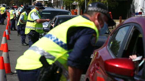 NSW police patrol a coronavirus checkpoint.