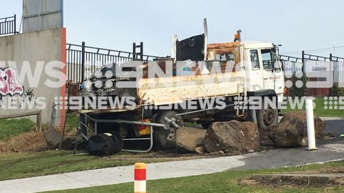 Environmental authorities are assessing if materials leaking from drums are hazardous after a truck overturned in Campbellfield. 