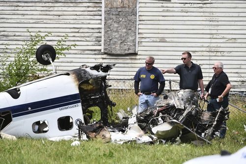 NTSB agents work at the site of a fatal small plane crash site in a field in Detroit. Picture: AAP