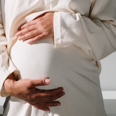 Pregnant woman holding her belly