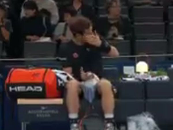 Andy Murray reacts after a ball girl throws a ball at him and knocks his drink bottle out of his hand. (Supplied)