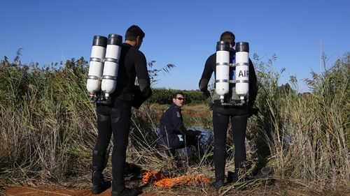 Members of the police dive unit prepare to search an irrigation channel for the body of teacher Stephanie Scott on the outskirts of Leeton, in the NSW Riverina, Friday, April 10, 2015