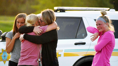 People console each other after a shooting at Cornerstone Church on Thursday, June 2, 2022 in Ames, Iowa.