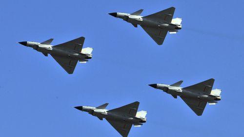 J-10 jet fighters perform in formation to celebrate the 60th anniversary of the People's Liberation Army Air Force in Beijing, China, Nov. 15, 2009. 