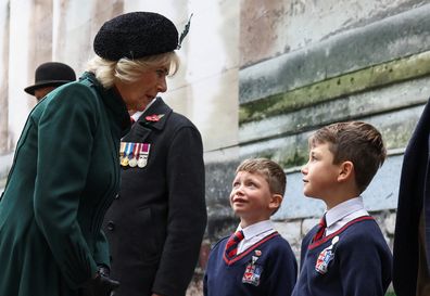 Camilla, Queen Consort speaks to children as she attends the 94th Year of The Field Of Remembrance at Westminster Abbey on November 10, 2022 in London 
