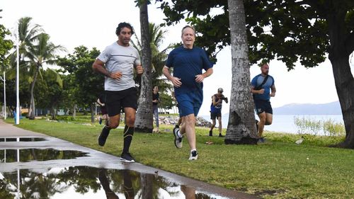 Bill Shorten goes for his morning jog in Townsville with NRL legend Johnathan Thurston.