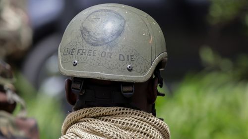 A Kenyan special forces soldier stands watch outside the compound.