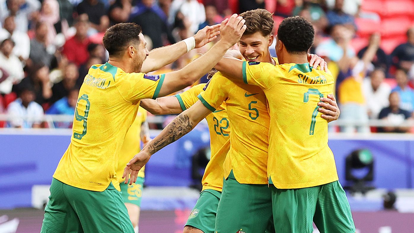 Jordan Bos of Australia celebrates with team mates after scoring their sides second goal during the AFC Asian Cup Group B match between Australia and India at Ahmad Bin Ali Stadium on January 13, 2024 in Doha, Qatar. (Photo by Robert Cianflone/Getty Images)