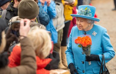 The Queen all smiles at church at St Peter and St Paul church