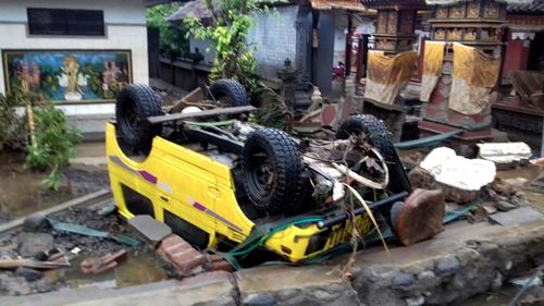 A car was thrown onto its roof by the force of the wave sweeping through coastal villages.