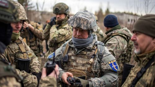 Members of Ukraine's Territorial Defense Forces during training at a former asphalt factory on the outskirts of Kyiv, Ukraine.