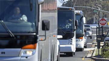 Three buses leave Travis Air Force Base carrying passengers that were aboard the Diamond Princess cruise ship.