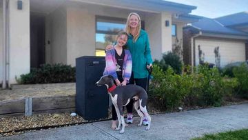 Melissa Watt and her daughter Belle, with their dog Snoop, outside their home in the Woodlea housing development. 