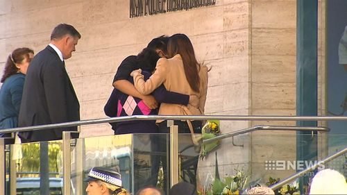 The Cheng family embraced at the scene. (9NEWS)