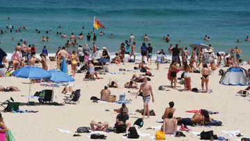 Beachgoers are see at Bondi Beach in Sydney during a major heatwave in January.