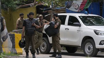 Police officers prepare to take position outside the residence of Pakistan&#x27;s former Prime Minister Imran Khan, in Lahore, Pakistan, Saturday, Aug. 5, 2023.