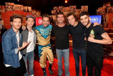 Louis Tomlinson, Niall Horan, Liam Payne, Simon Cowell, Harry Styles, and Zayn Malik on set during One Direction celebrates 1D Day at YouTube Space LA in Playa Vista, California on November 23, 2013